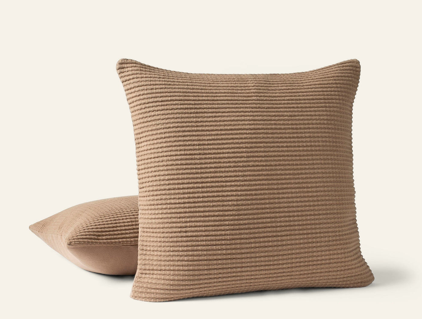 Coyuchi Marshall pillow covers in camel, ribbed texture detail, two cushions stacked.