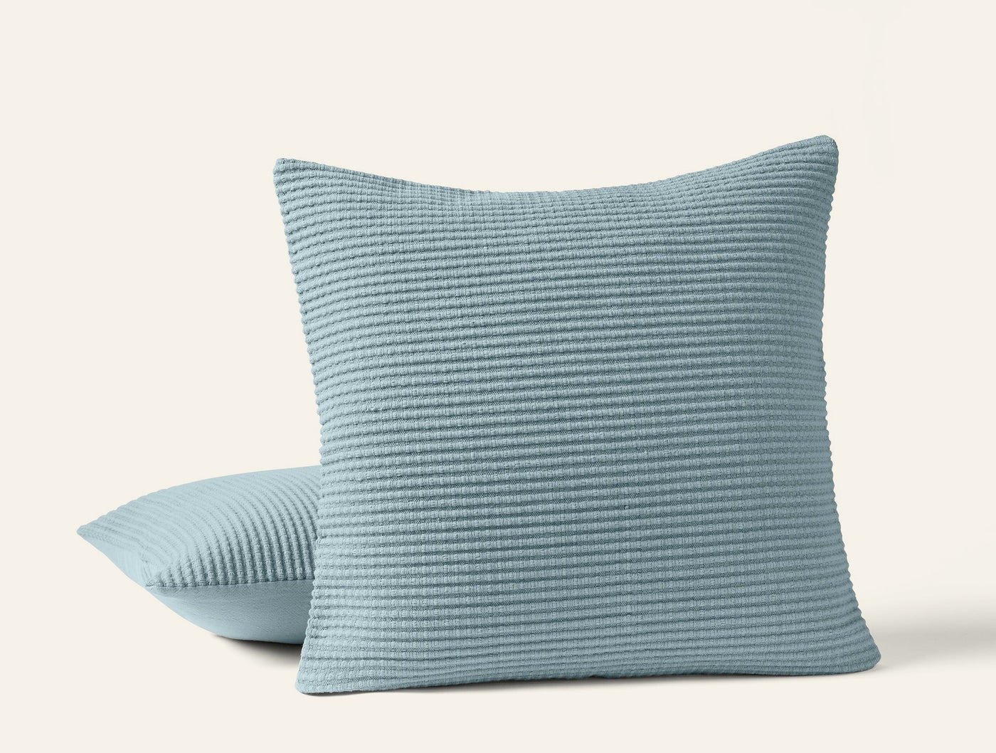 Coyuchi Marshall pillow covers in sky blue, horizontal ribbed texture, two cushions stacked.