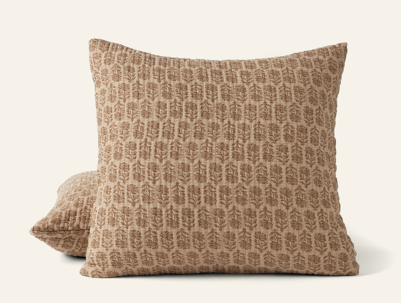 Coyuchi Mirada Matelassé pillow sham in camel with tone-on-tone botanical block print.