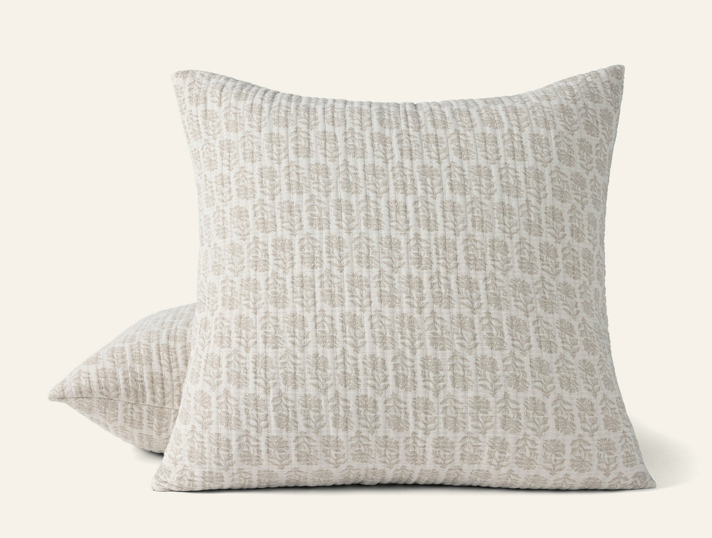 Two Coyuchi Mirada Matelasse shams stacked, ivory with grey botanical print.