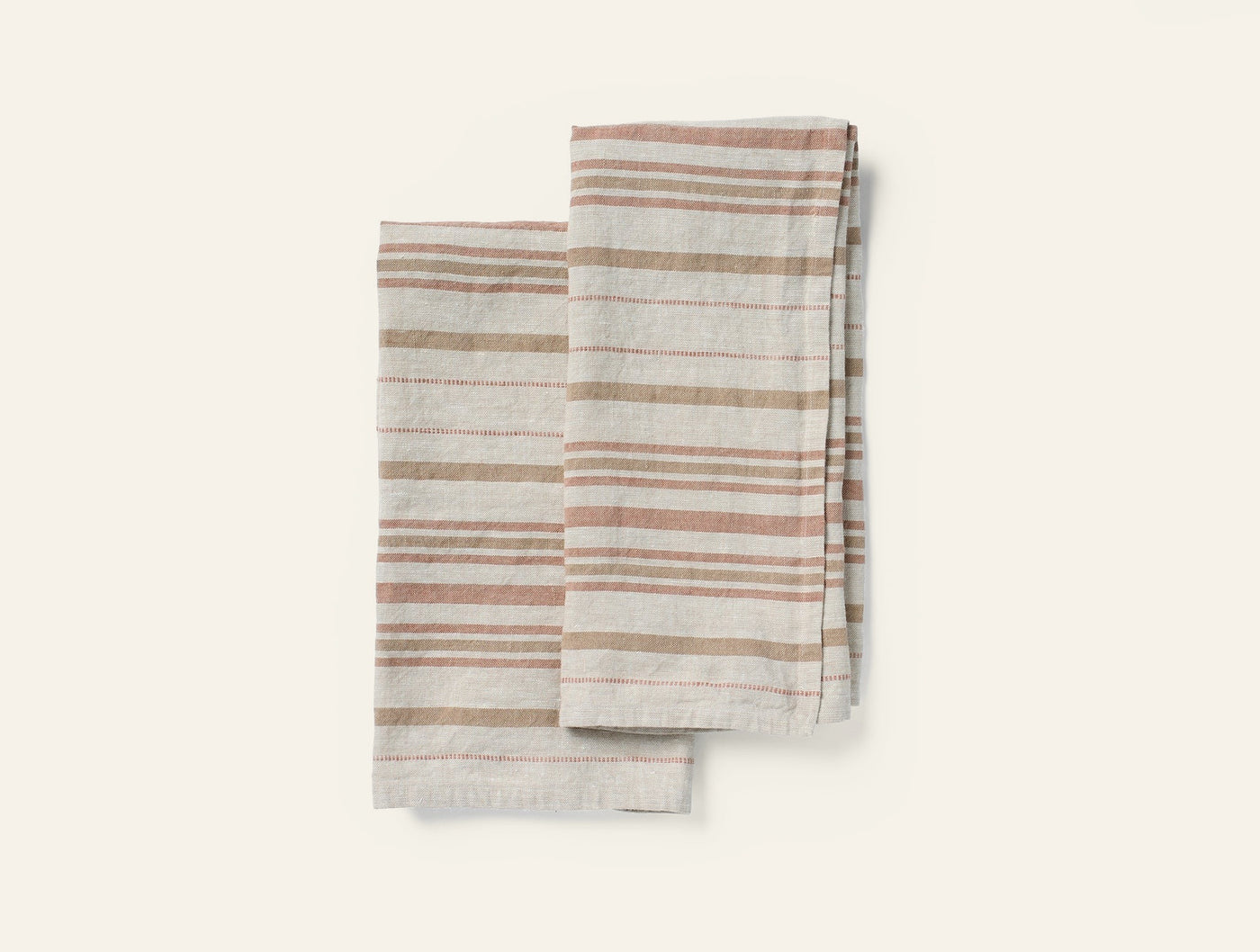Folded pair of striped linen hand towels in warm terra and sage tones on white ground.