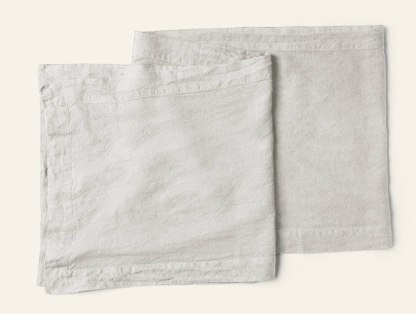 Coyuchi Mojave Linen napkins in natural, two folded squares showing relaxed texture.
