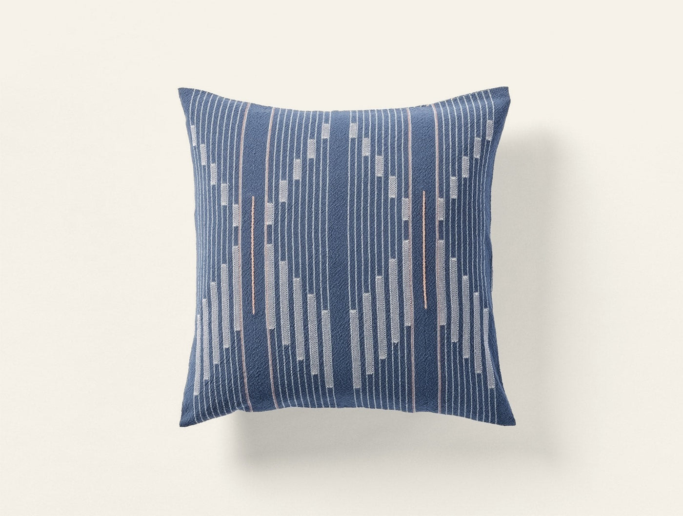 Coyuchi Morelia pillow, close-up of woven geometric stripe pattern in navy and copper.