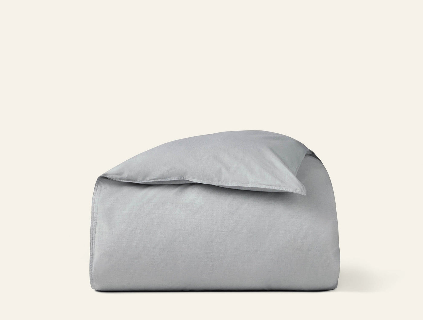 Coyuchi Crinkled Percale duvet cover folded with pillow in silver-grey.