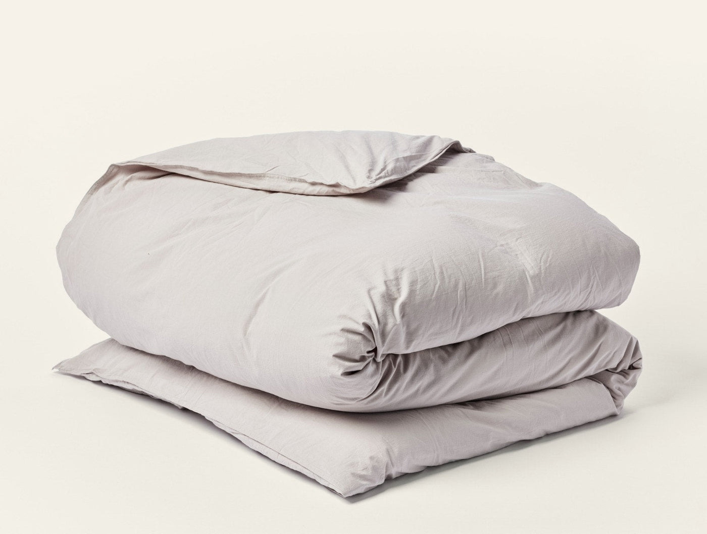 Coyuchi Crinkled Percale duvet cover in taupe, neatly folded to show texture.