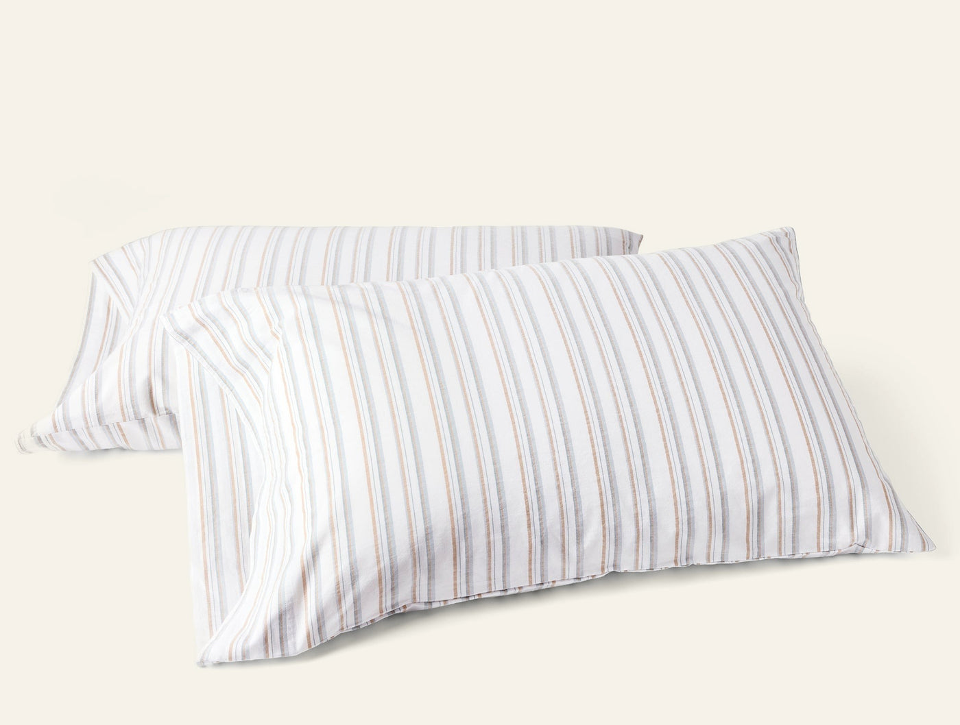 Pair of Coyuchi Crinkled Percale pillowcases with multicolor thin stripes on white.