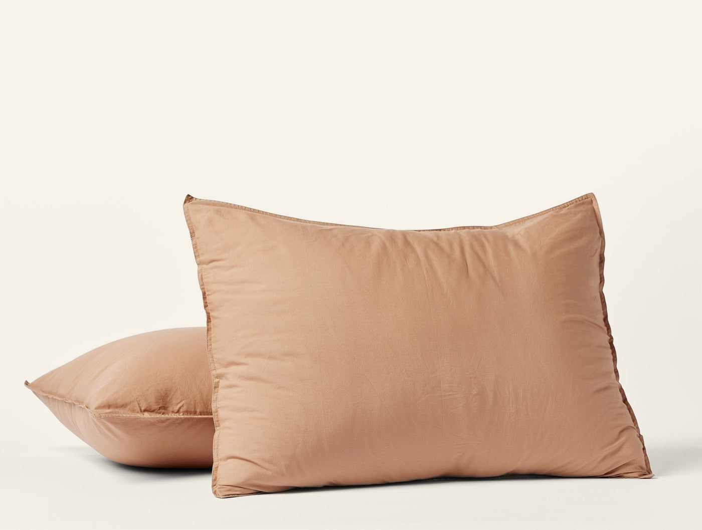 Two caramel crinkled percale pillow shams stacked against a white background.