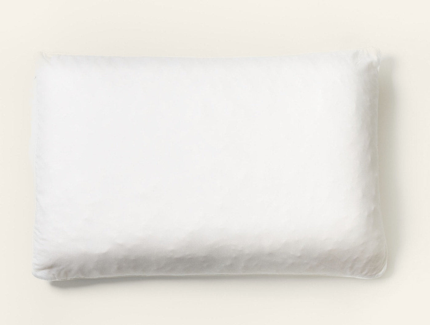 Overhead view of a white Coyuchi Latex pillow with softly rumpled linen casing.