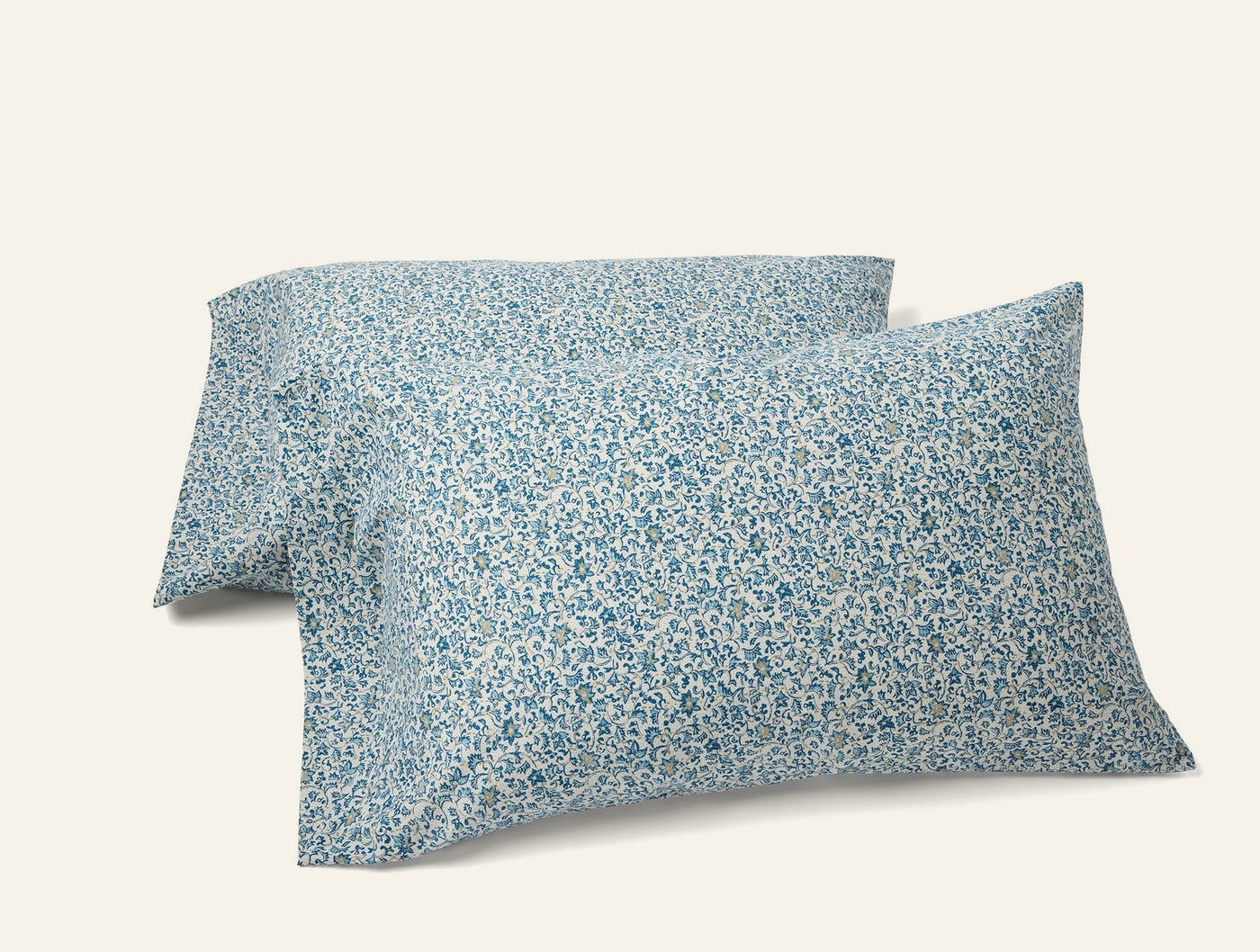 Pair of Coyuchi Print Percale pillowcases with blue floral pattern on white ground.