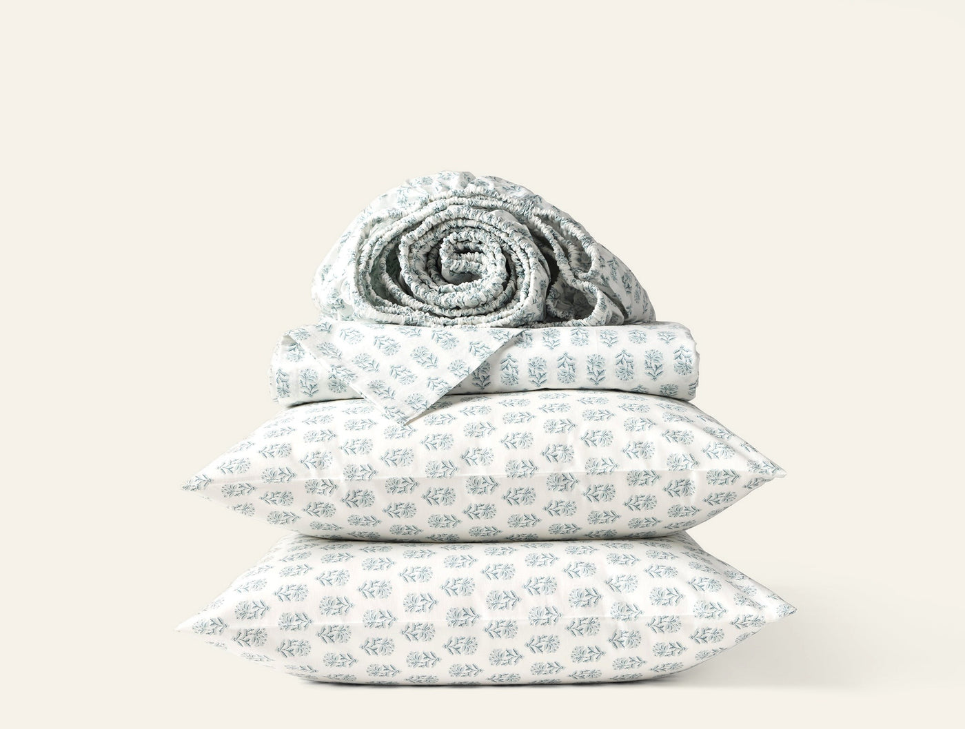 Coyuchi Print Percale sheet set in white with sage green botanical block print.