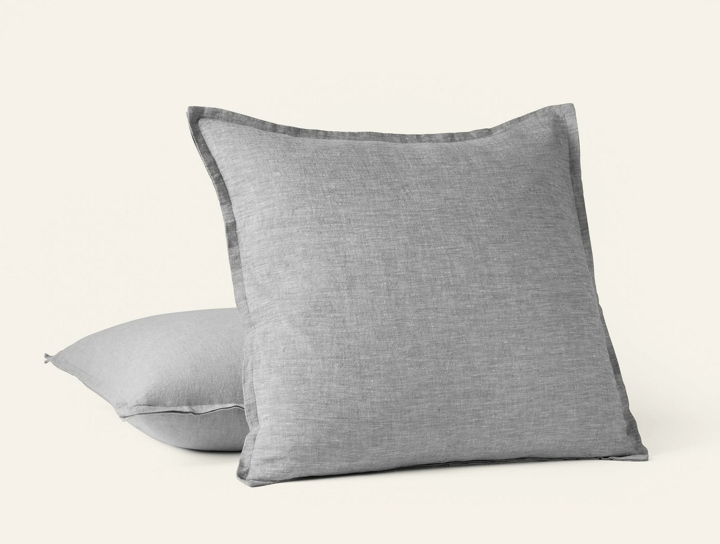 Coyuchi Relaxed Linen pillow in grey, showing frayed flange edge detail, pair stacked.