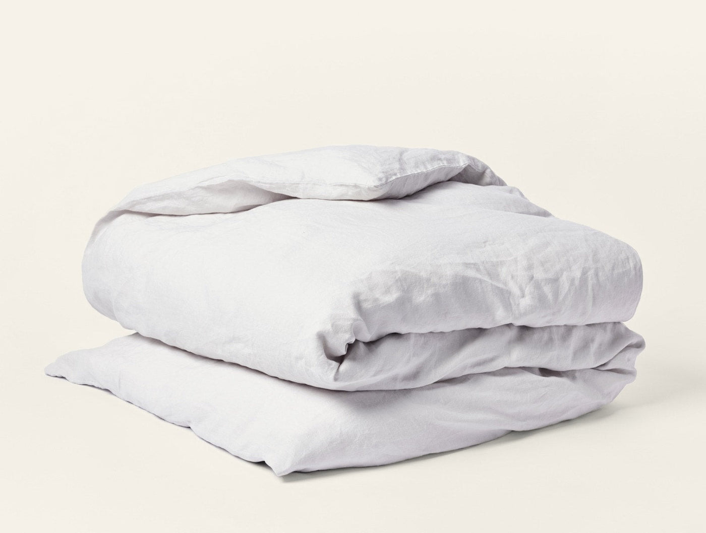 Coyuchi Relaxed Linen duvet cover folded, shown in soft silver-grey against white background.