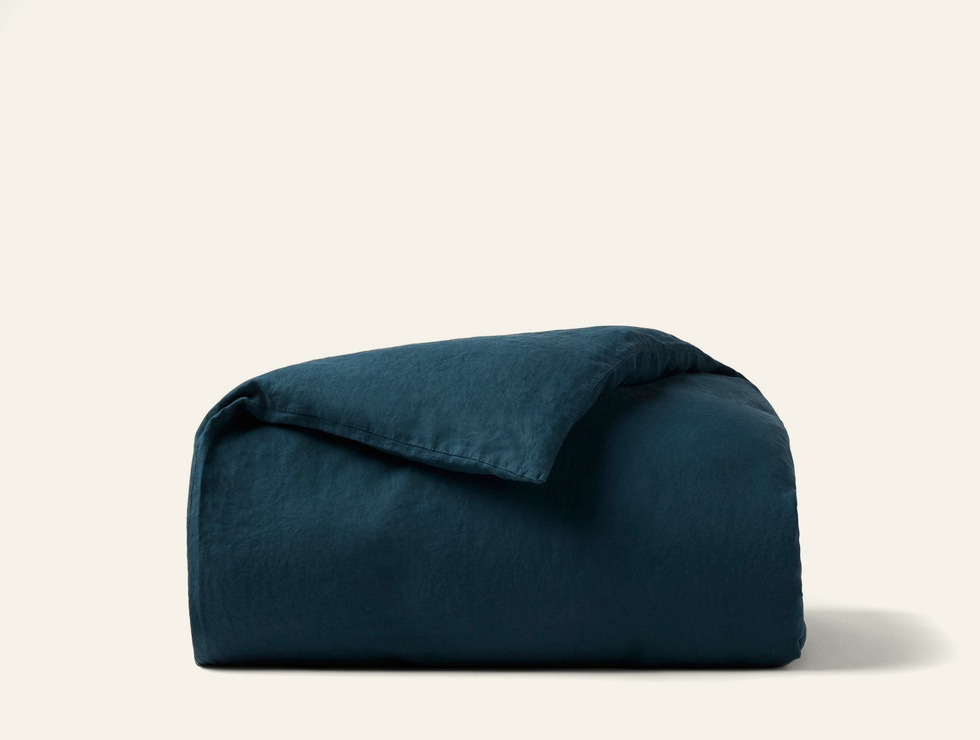 Coyuchi Relaxed Linen duvet cover in deep teal, folded to show texture.