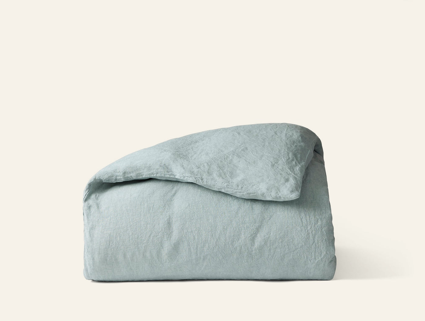 Coyuchi Relaxed Linen duvet cover folded, seafoam, showing natural wrinkled texture.