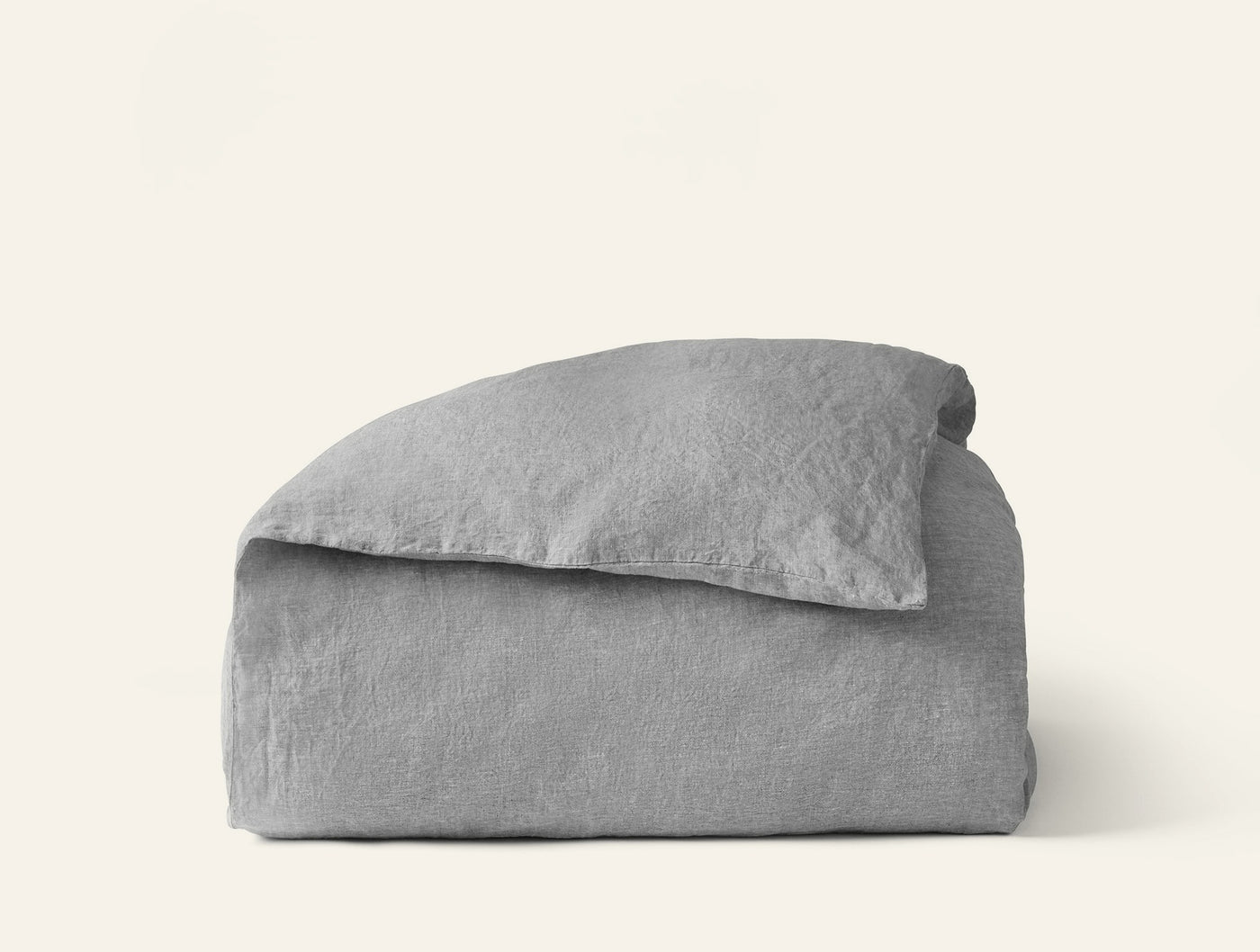 Close-up of folded Coyuchi Relaxed Linen duvet cover in silver-grey, showing textured weave.