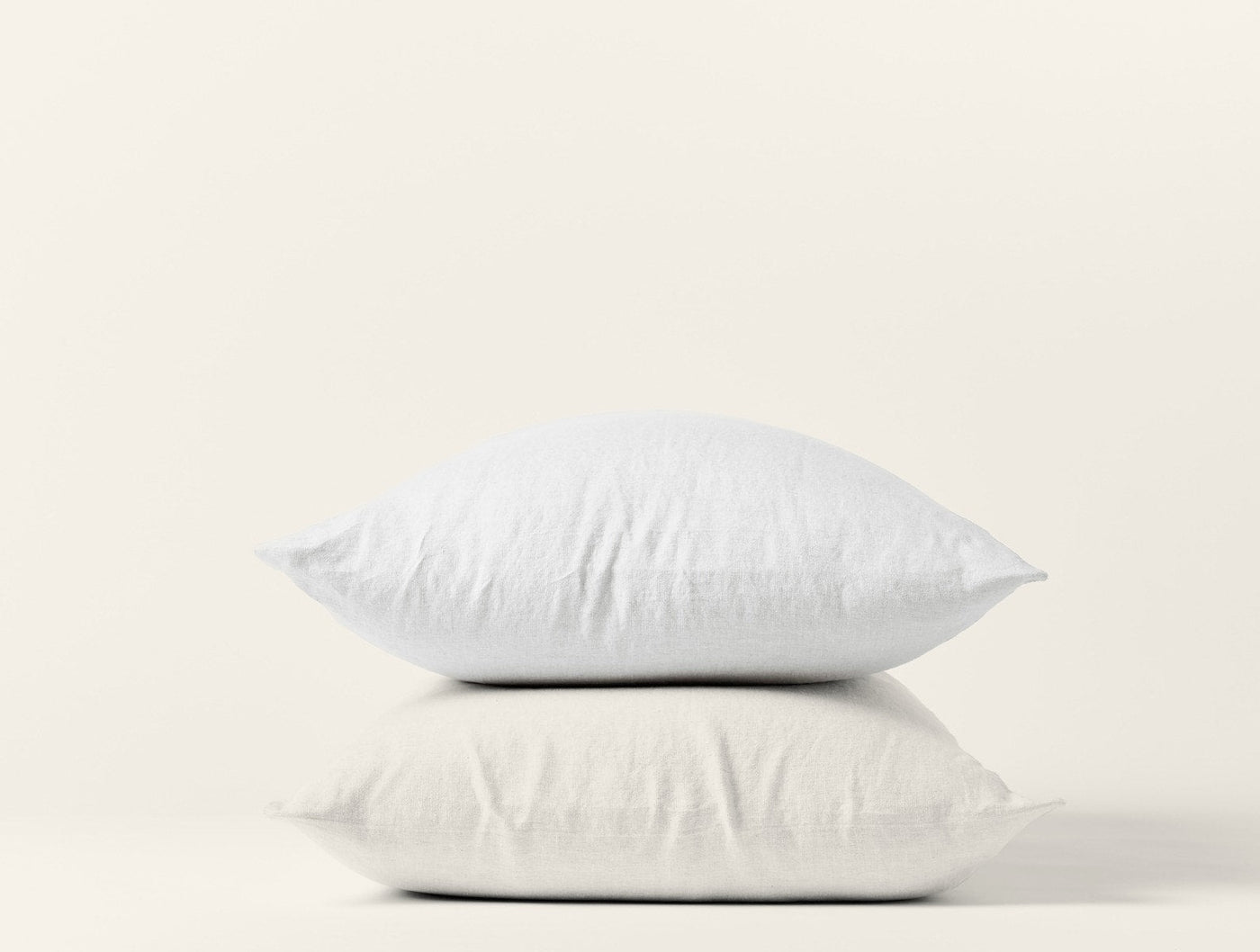 Coyuchi Relaxed Linen pillowcase pair in white, two pillows stacked on white background.