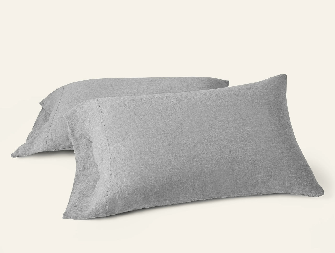 Close-up of two Coyuchi Relaxed Linen pillowcases in heathered gray, stacked at an angle.