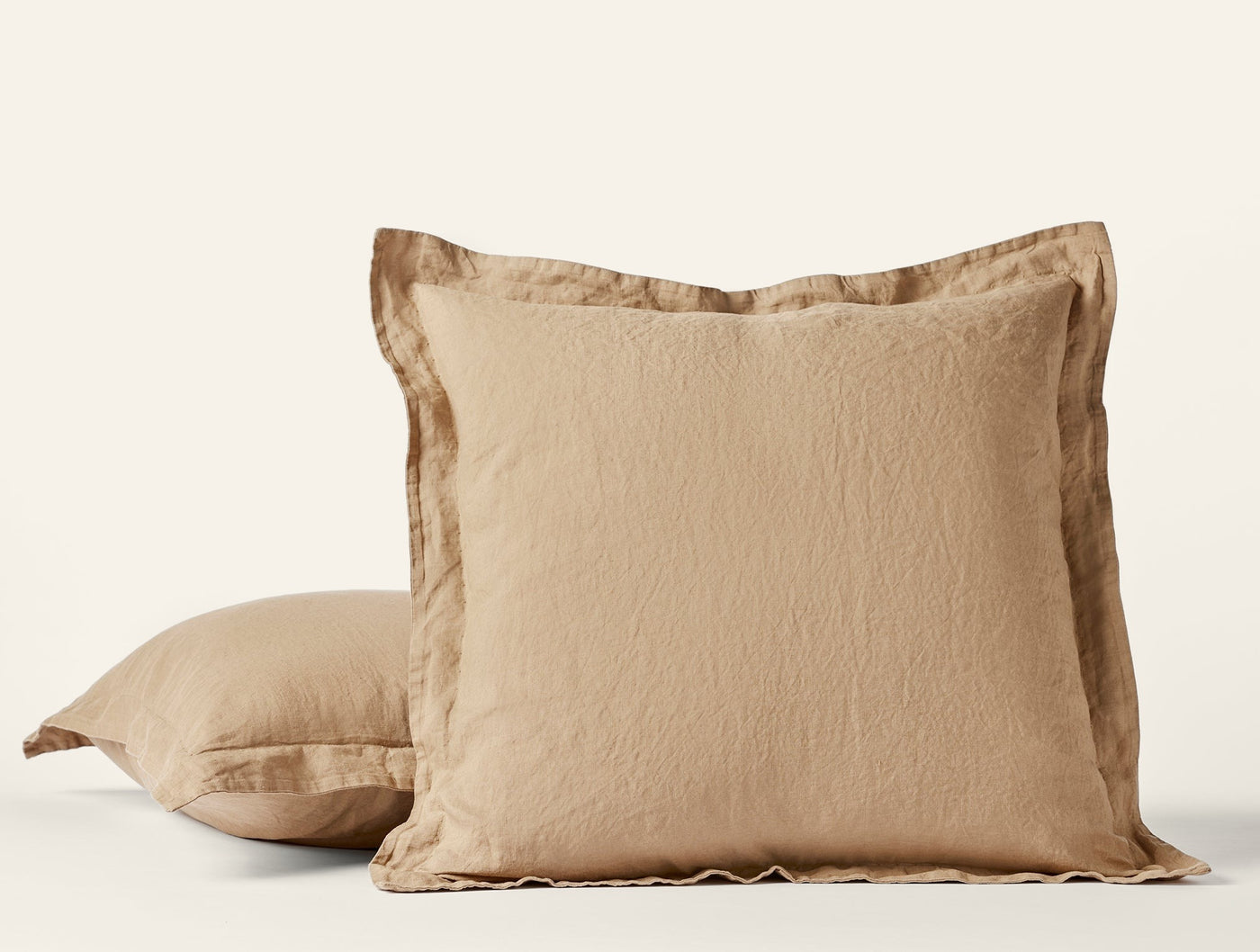 Two Coyuchi Relaxed Linen shams in camel, stacked and styled against a white background.