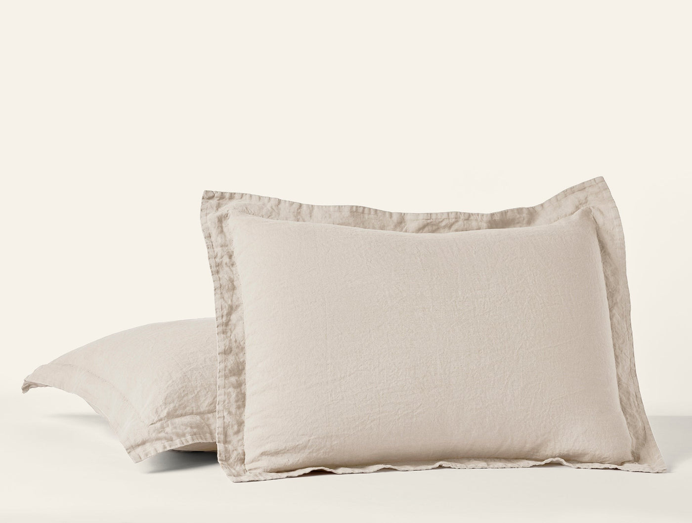 Close-up of Coyuchi Relaxed Linen pillow shams in natural, showing flanged edge detail.