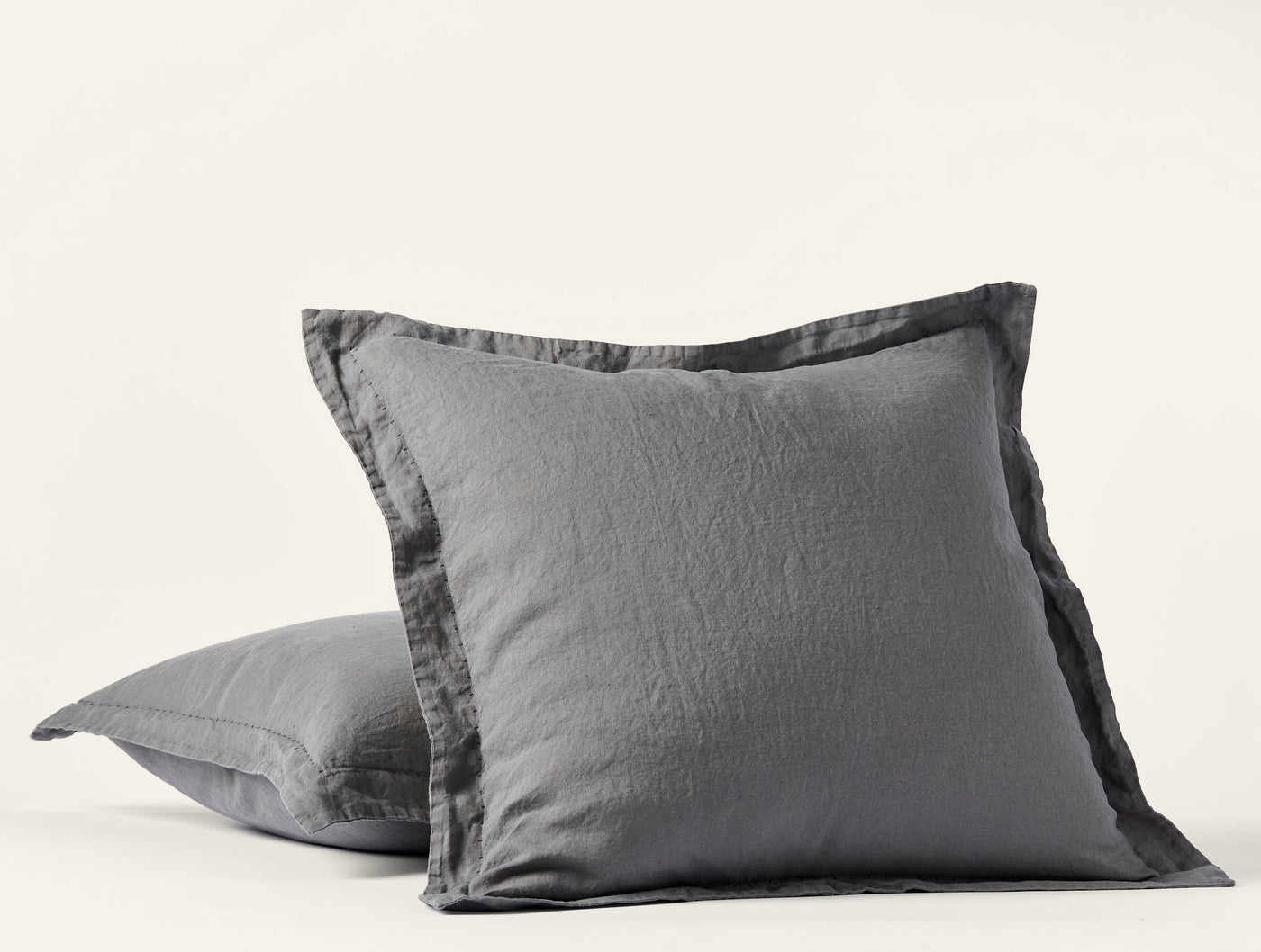 Close-up of Coyuchi Relaxed Linen sham pair in slate grey with flanged edge detail.