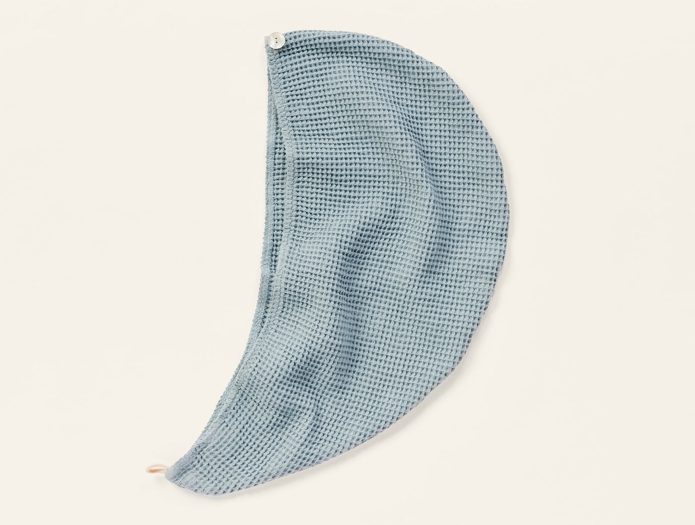 Coyuchi Waffle Hair Wrap in slate blue, shown draped open to reveal waffle-weave texture.