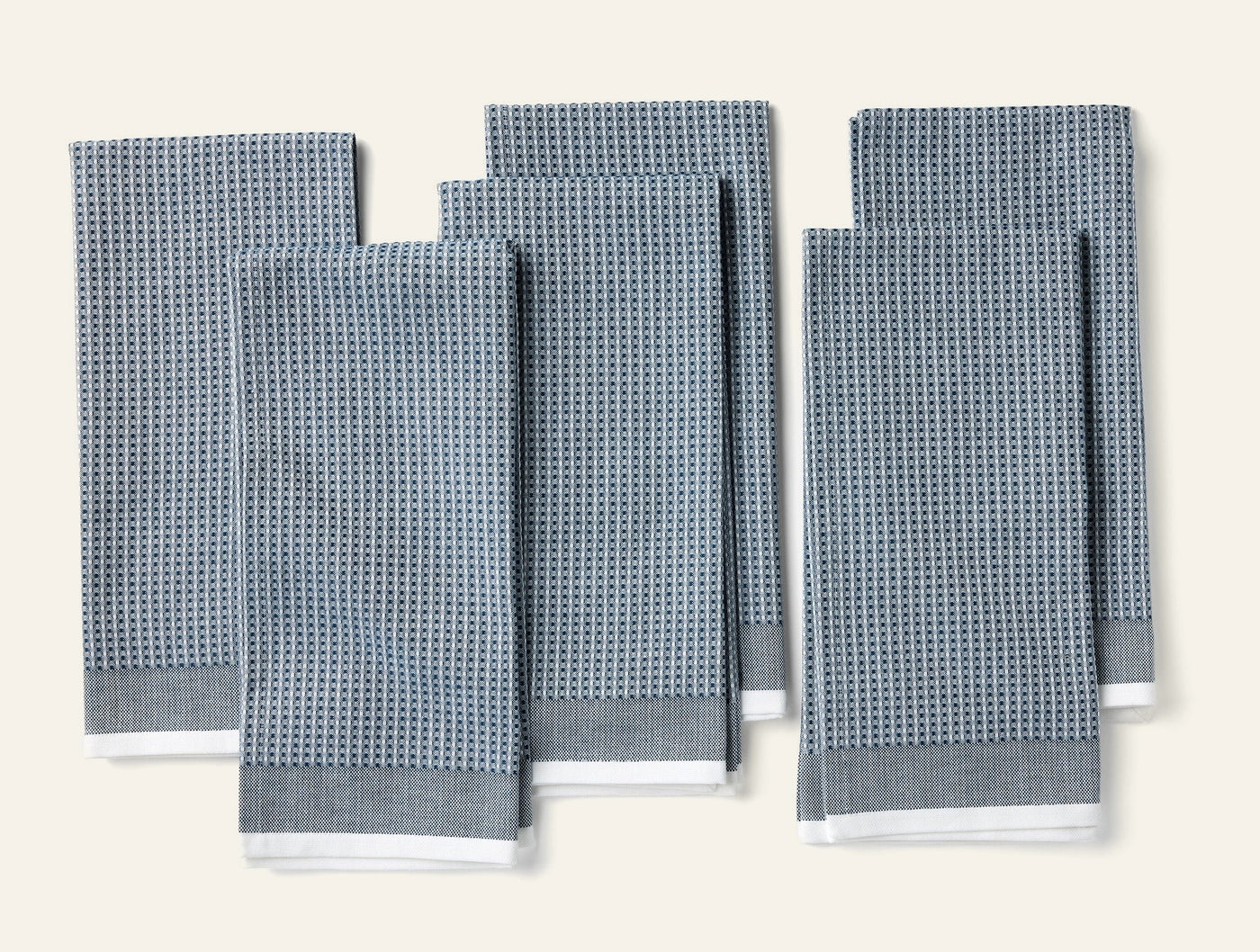 Coyuchi slate blue waffle-weave kitchen towels, set of six folded flat.