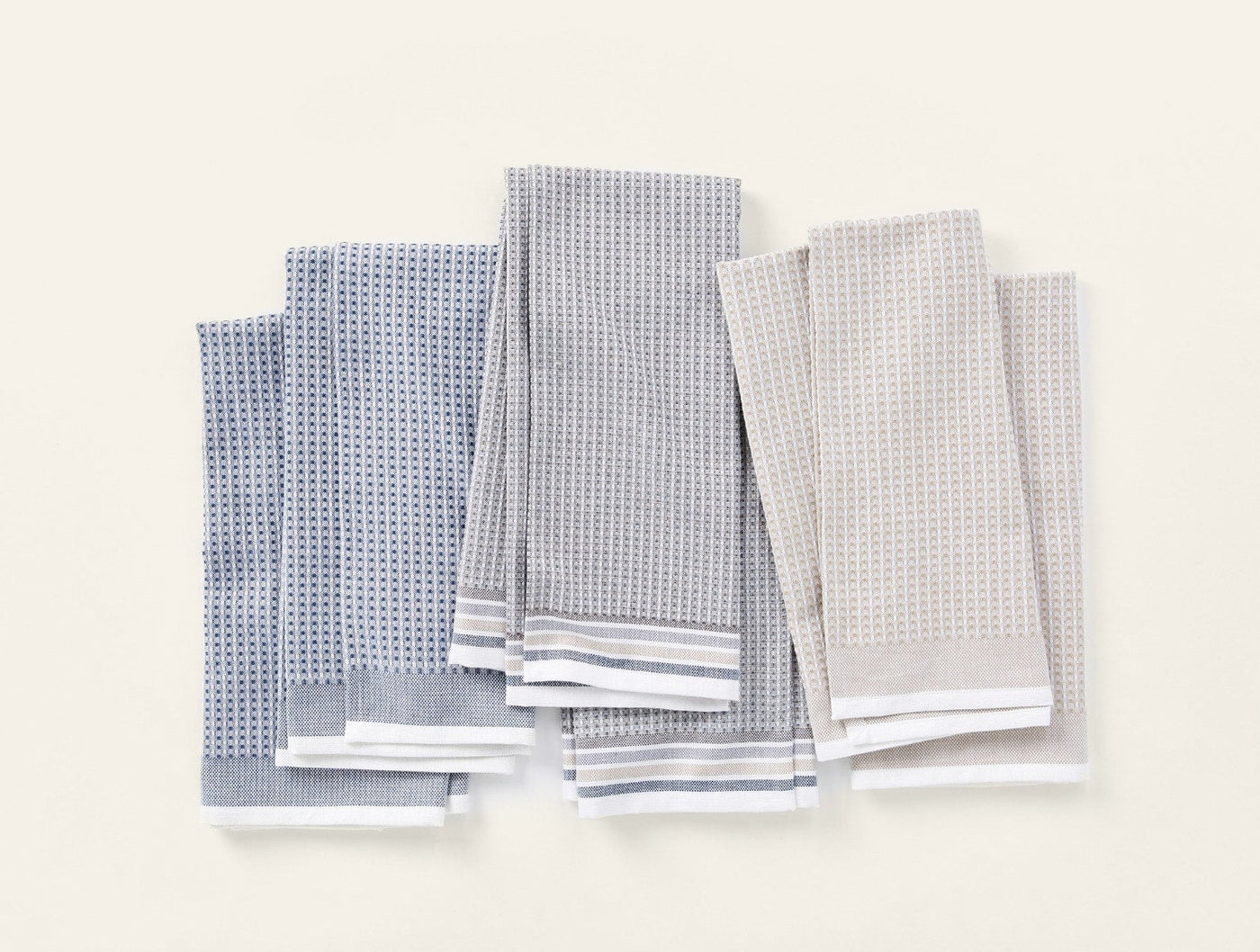 Coyuchi Waffle kitchen towels in slate and fog, waffle-weave texture with stripe hem detail.