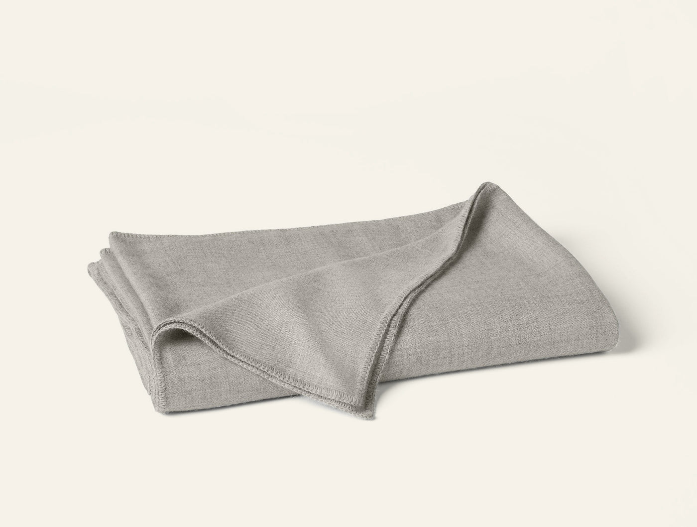 Folded silver grey baby alpaca blanket with ribbed edges, shown on white background.