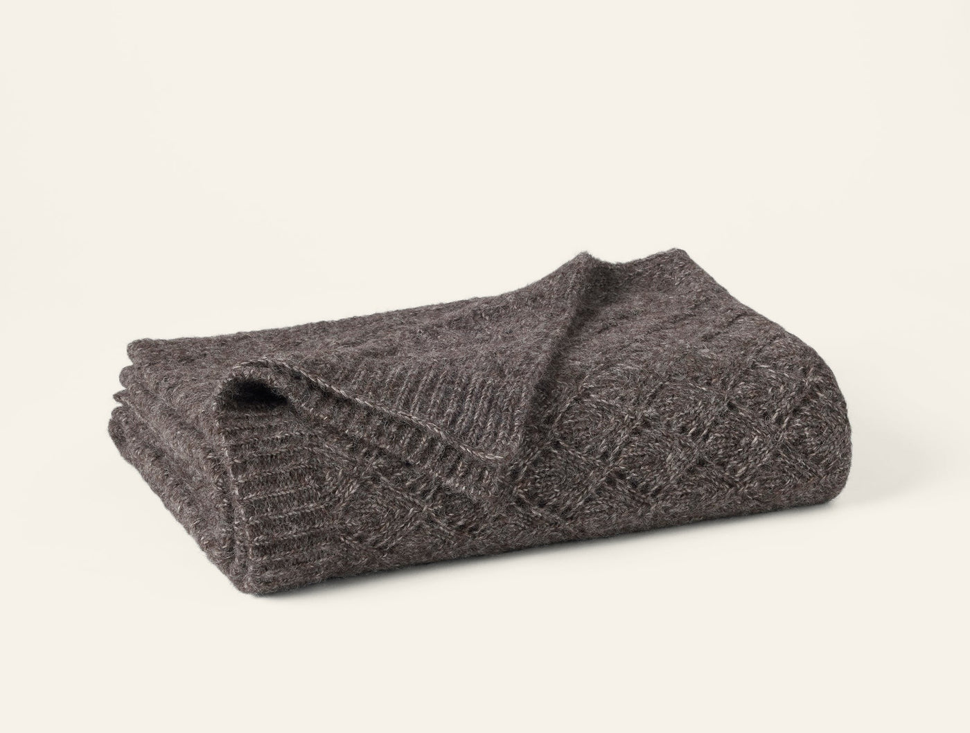 Coyuchi Paracas Alpaca Cotton Knit Throw in charcoal, folded to show diamond knit texture.