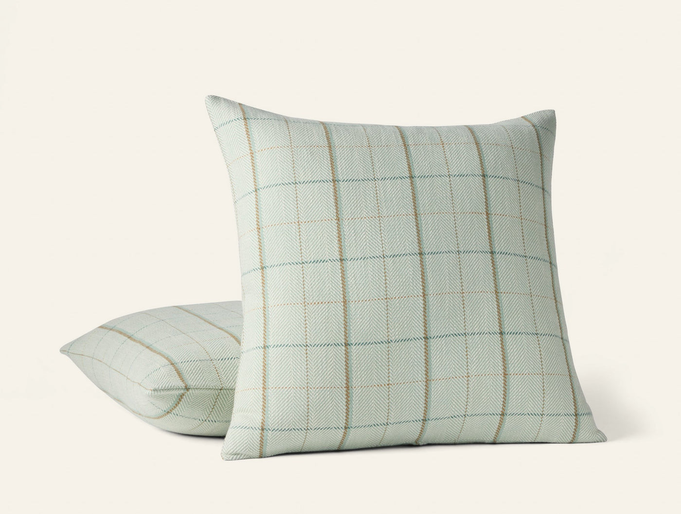 Coyuchi Paseo decorative pillow in sage green with woven grid plaid pattern, two sizes shown.