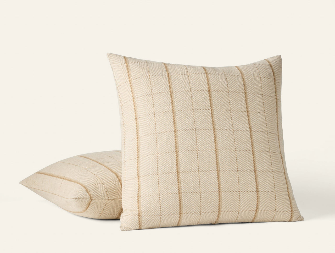 Coyuchi Paseo pillow covers in ivory, showing front and back views of woven grid pattern.