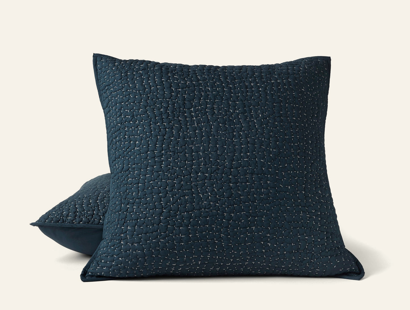 Close-up of Coyuchi Pebbled Handstitched sham in deep navy with textured kantha-style stitching.