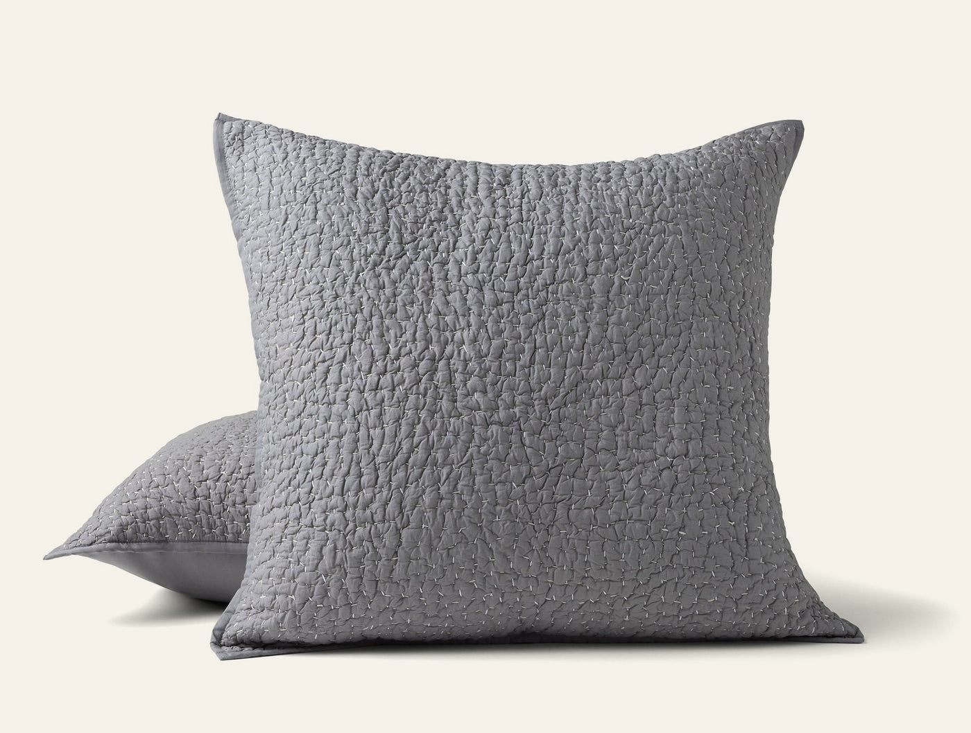 Two Coyuchi Pebbled Handstitched shams in slate grey with quilted texture, stacked.