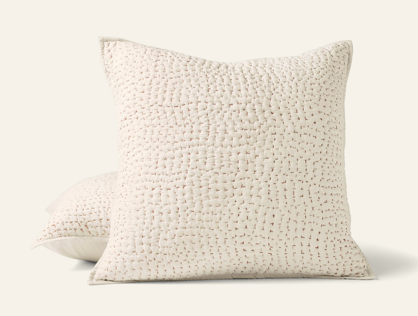 Close-up of Coyuchi Pebbled Handstitched sham in ivory, showing textured grid-stitch pattern.