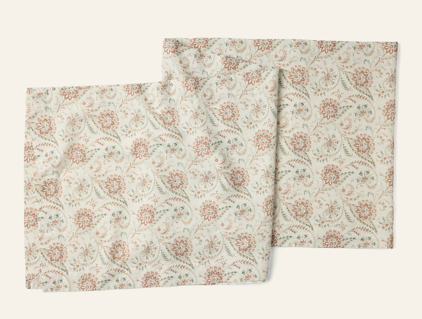 Pair of ivory Coyuchi Ponderosa table runners with dusty rose and sage floral print.