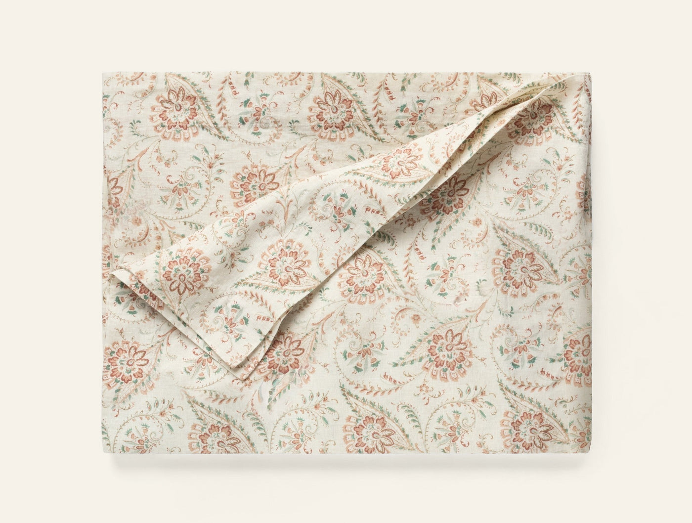 Coyuchi Ponderosa Print tablecloth folded flat, ivory with coral and sage floral print.