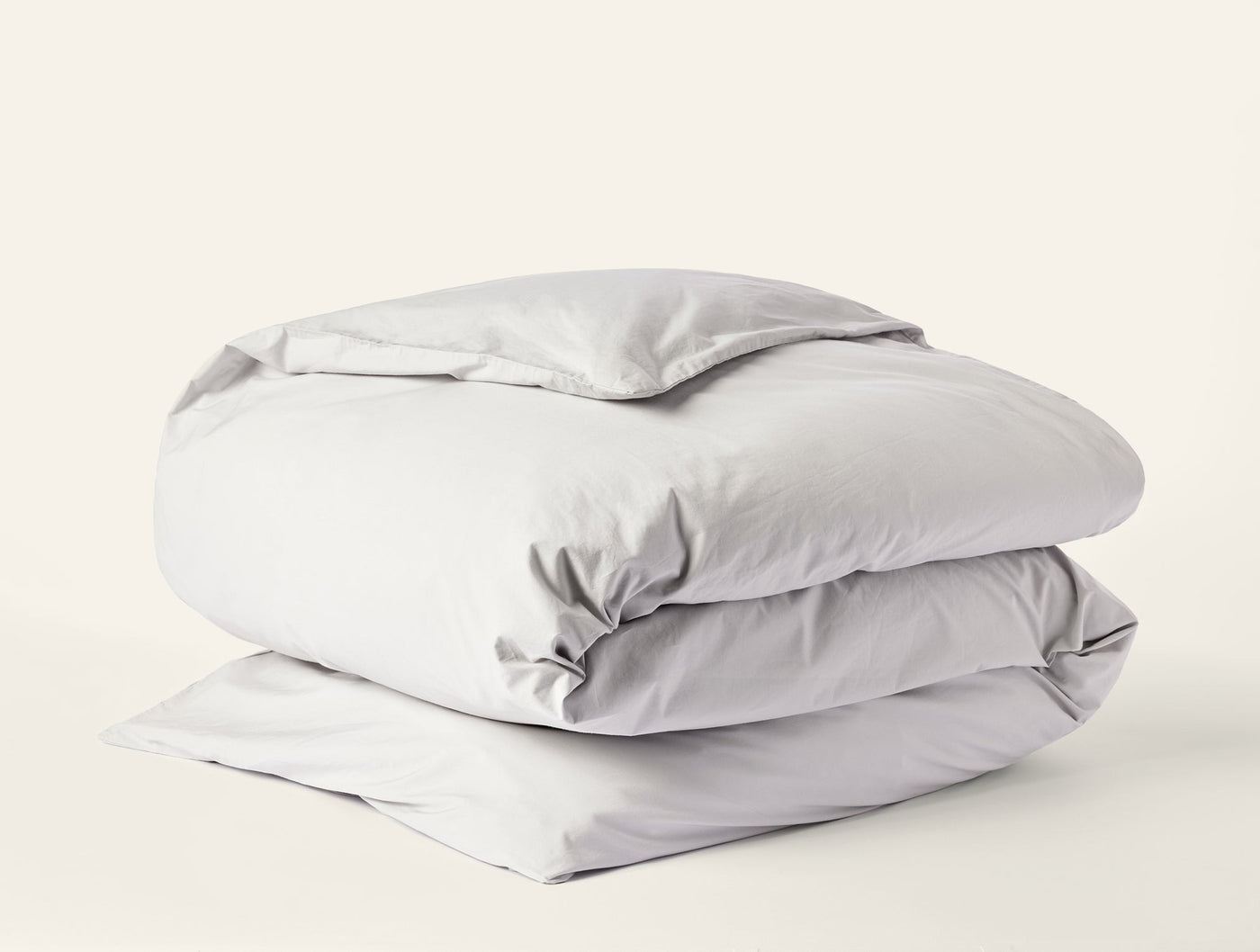 Coyuchi Refined Percale duvet cover folded neatly, shown in silver-grey percale cotton.