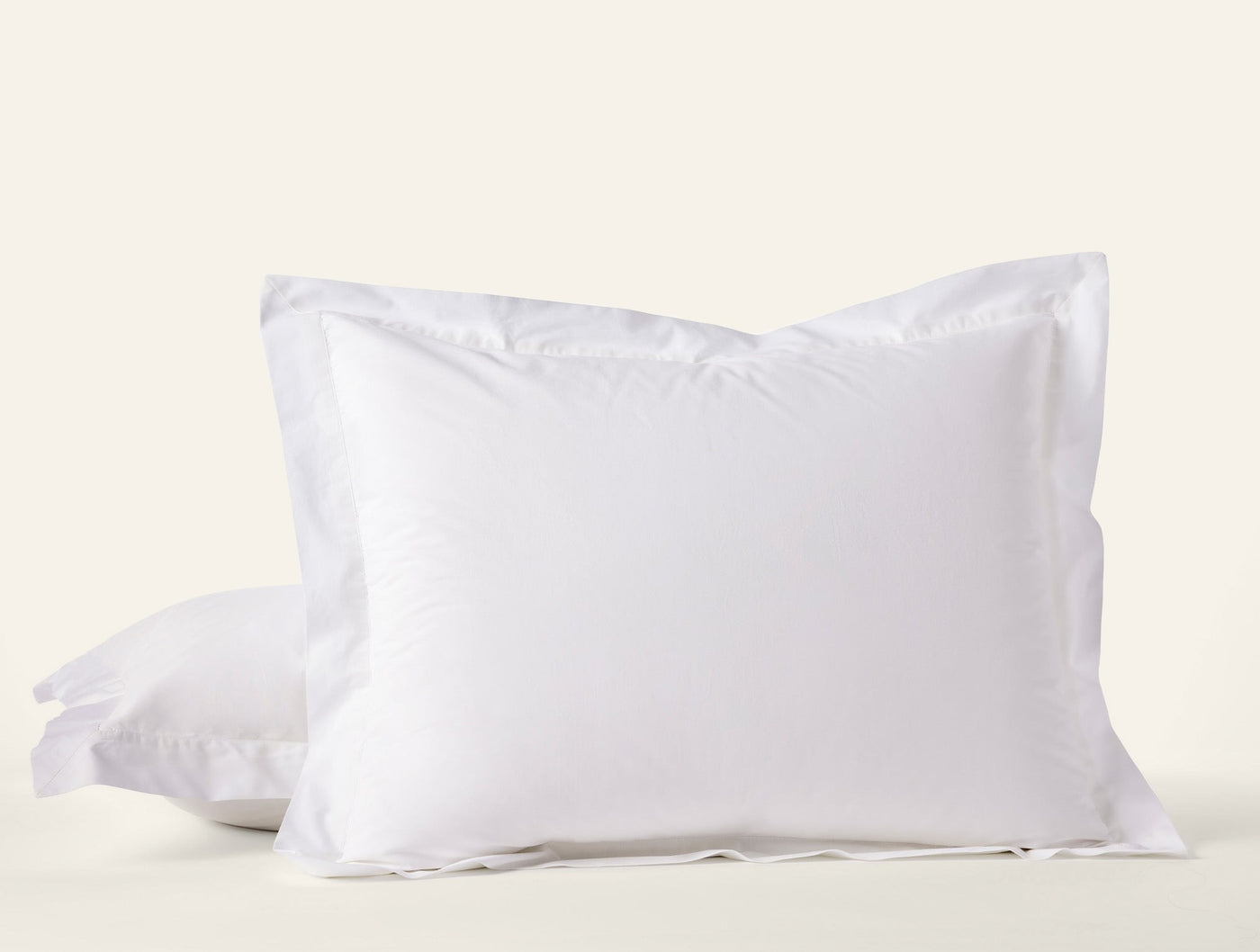 Coyuchi Refined Percale pillow sham in white, stacked pair with flanged border.