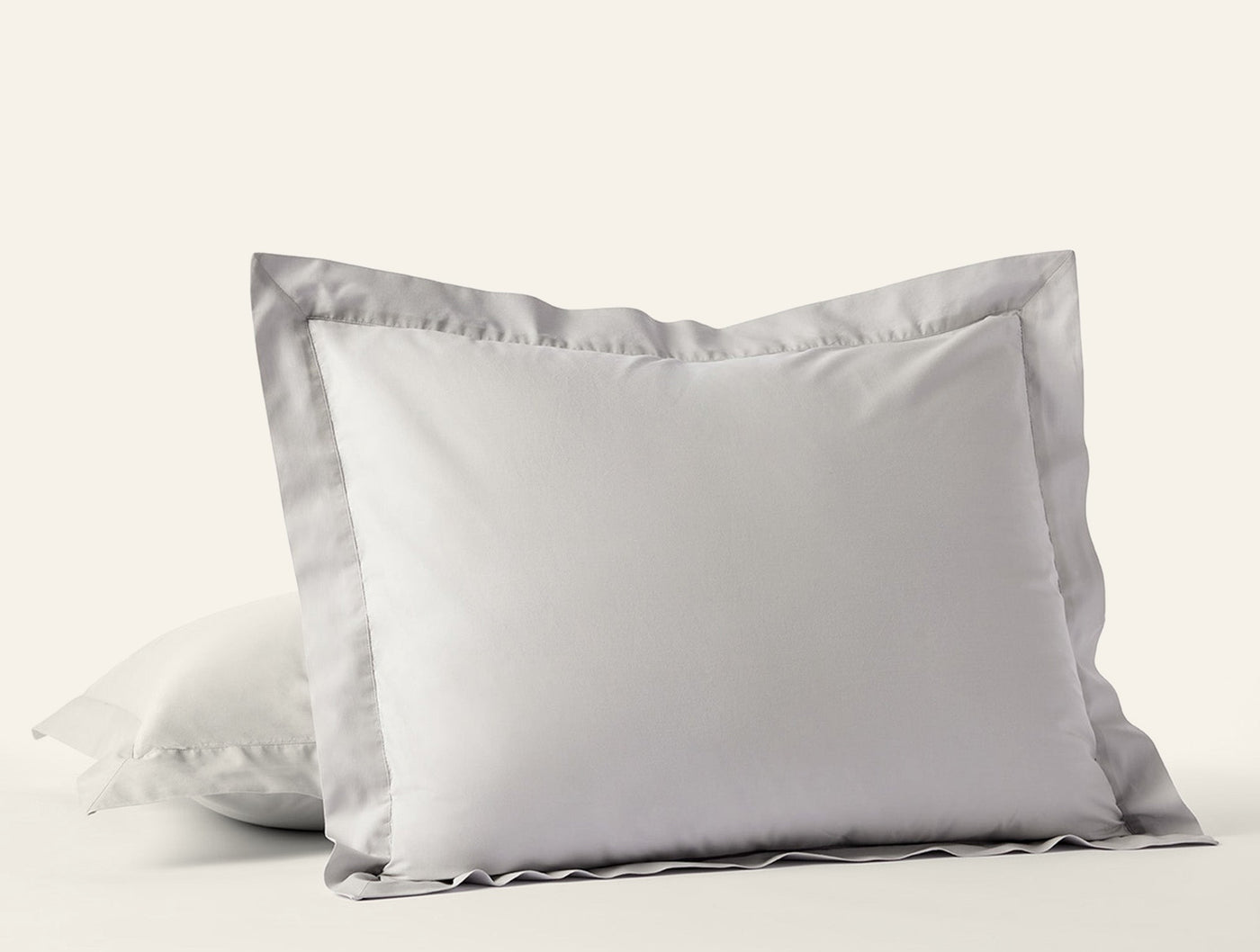 Two-tone white and silver grey euro shams stacked, showing contrast flange border detail.