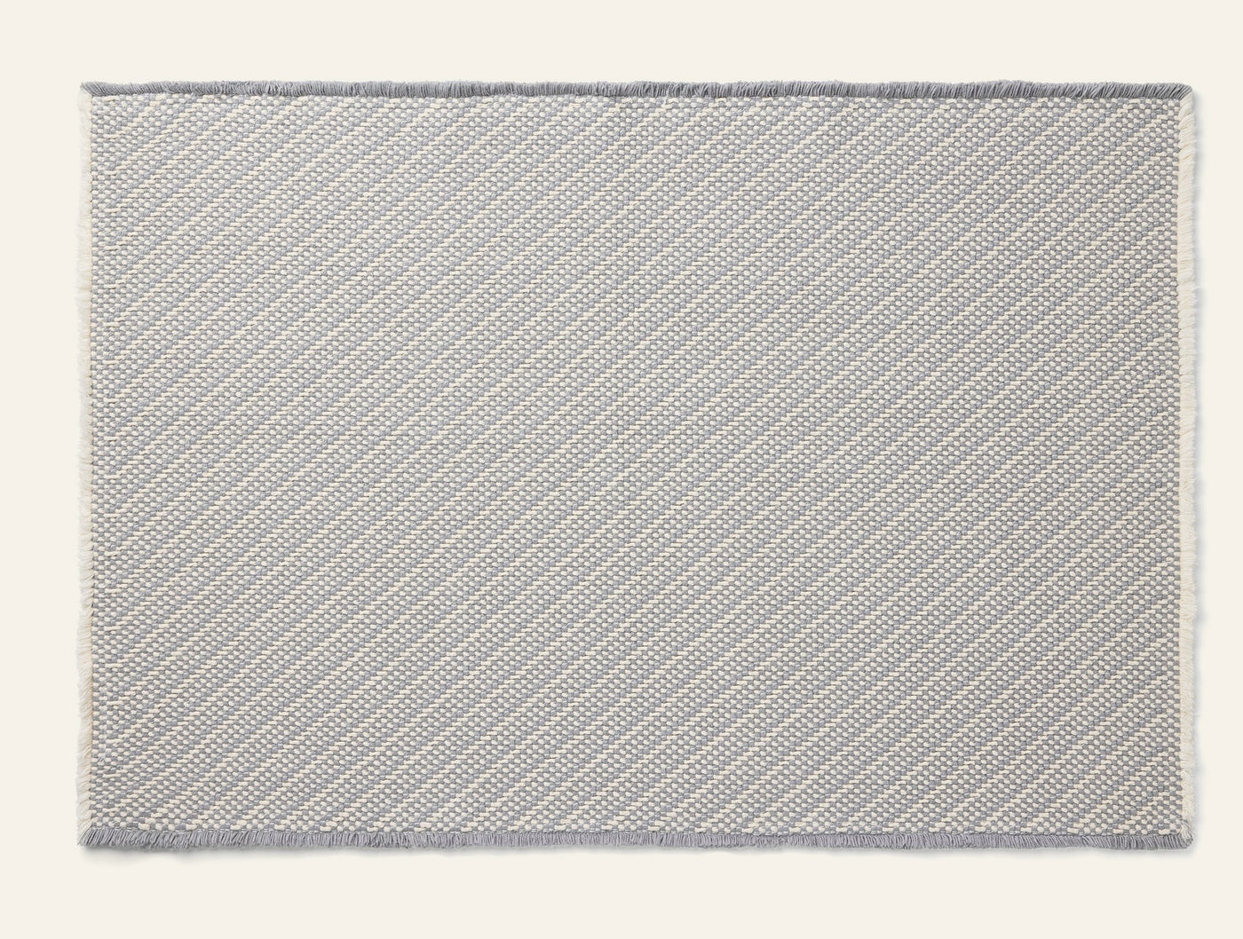 Coyuchi Ridge bath rug in silver with diagonal woven texture and ivory border.
