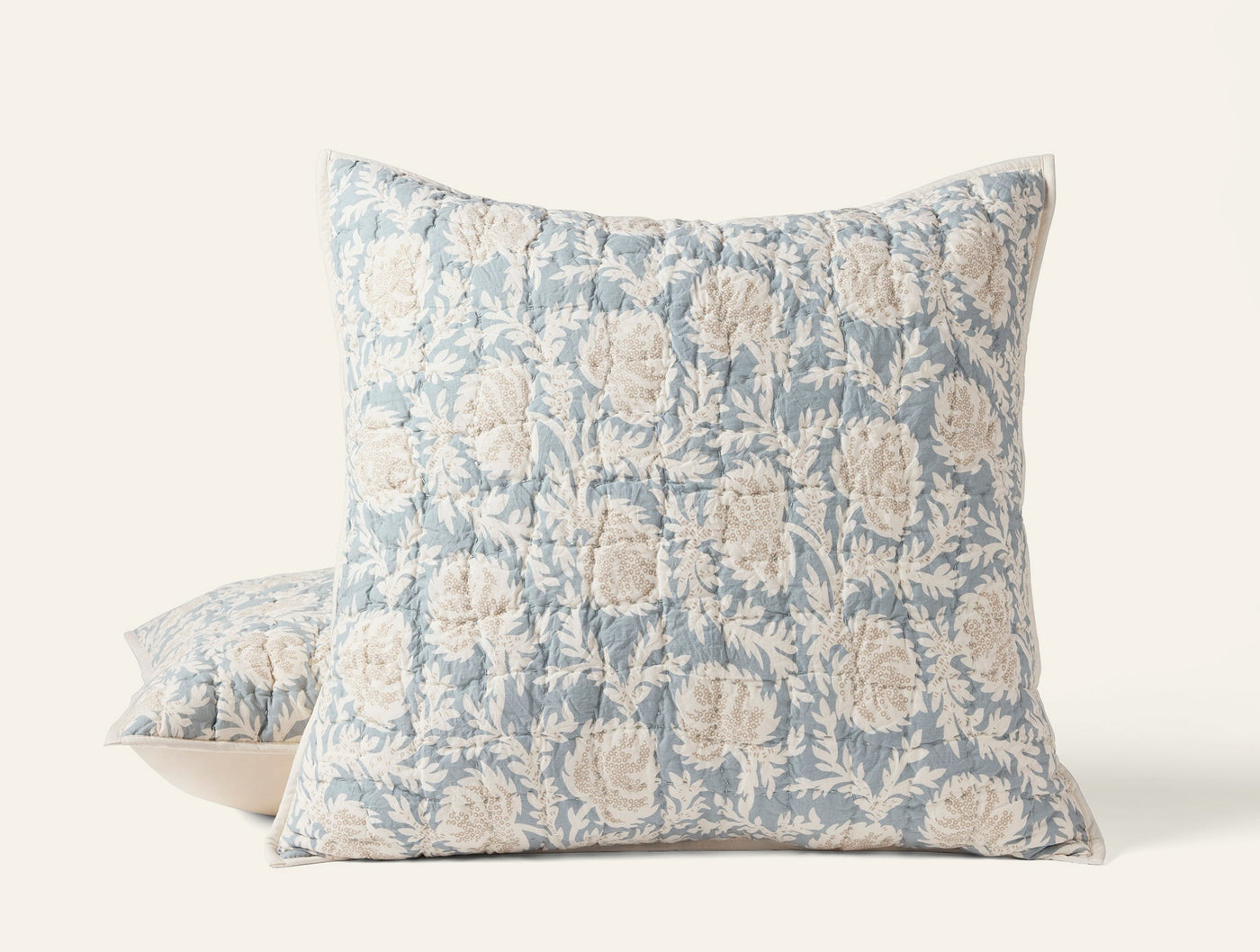 Two Coyuchi Robles shams stacked, dusty blue block-print floral pattern on quilted linen.