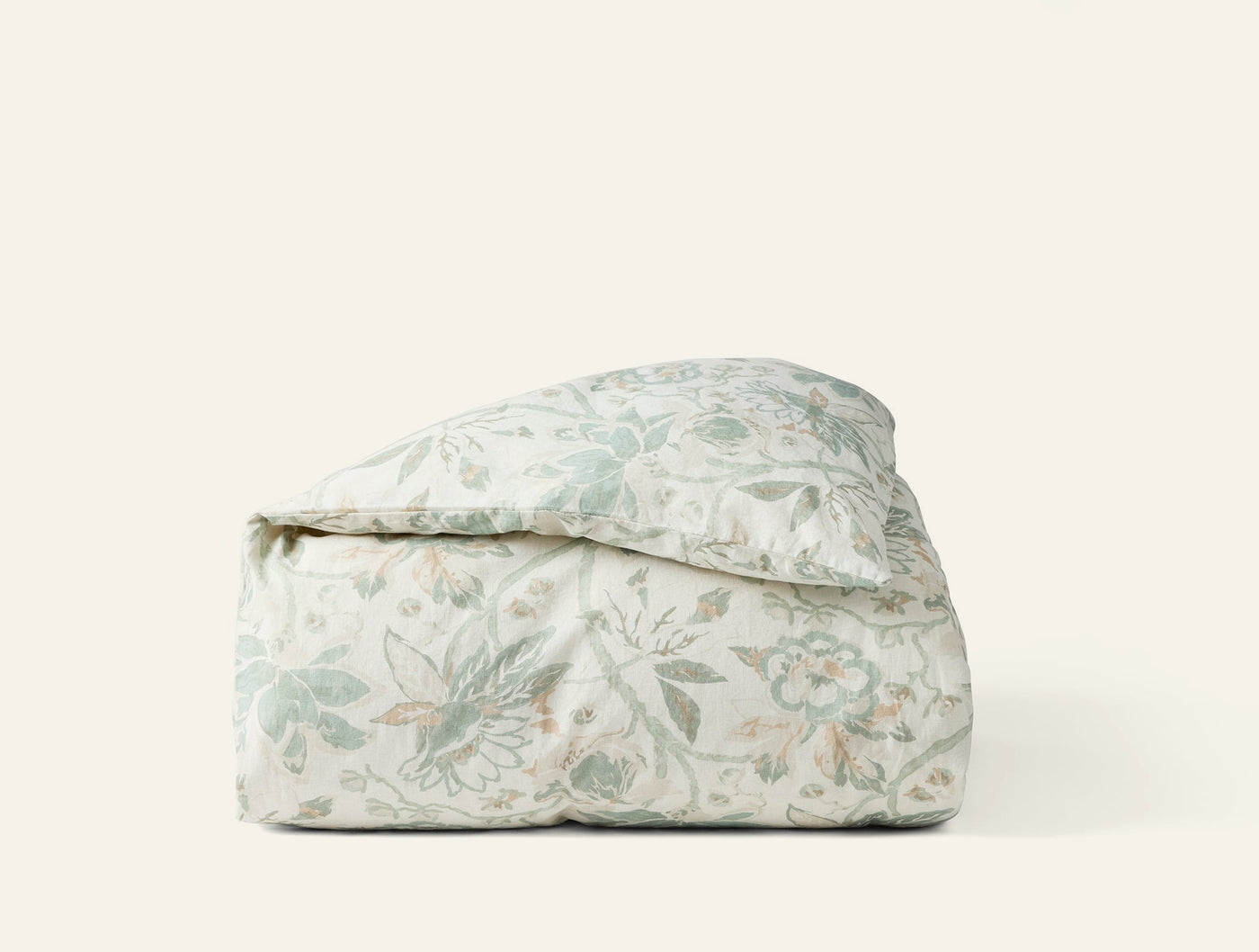Coyuchi Sea Bloom duvet cover folded, sage floral print on ivory cotton.