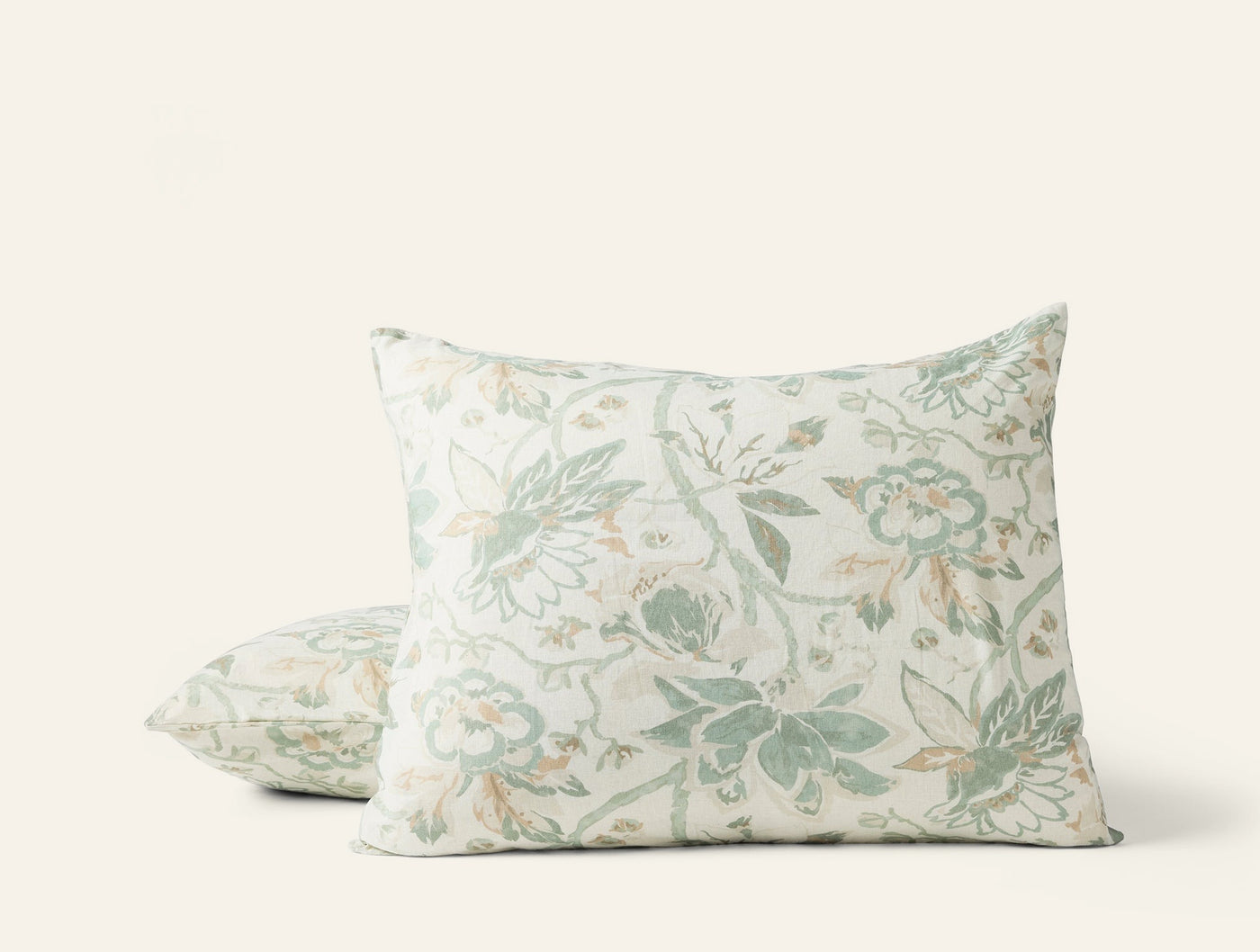 Two Coyuchi Sea Bloom pillow shams stacked, sage green floral print on ivory linen.