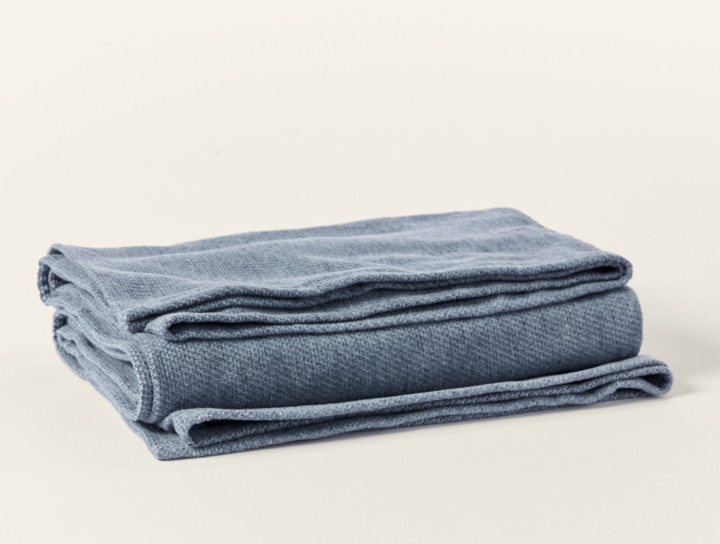 Coyuchi Sequoia Washable blanket in slate blue, folded to show textured weave.