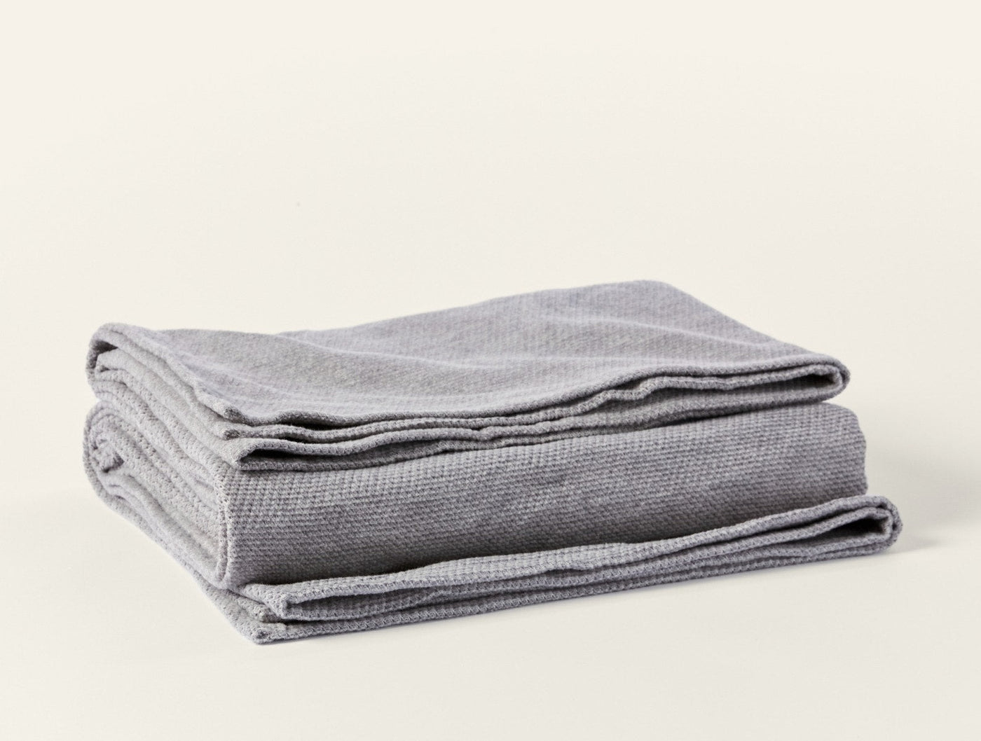 Coyuchi Sequoia blanket folded, showing silver grey waffle-knit texture detail.