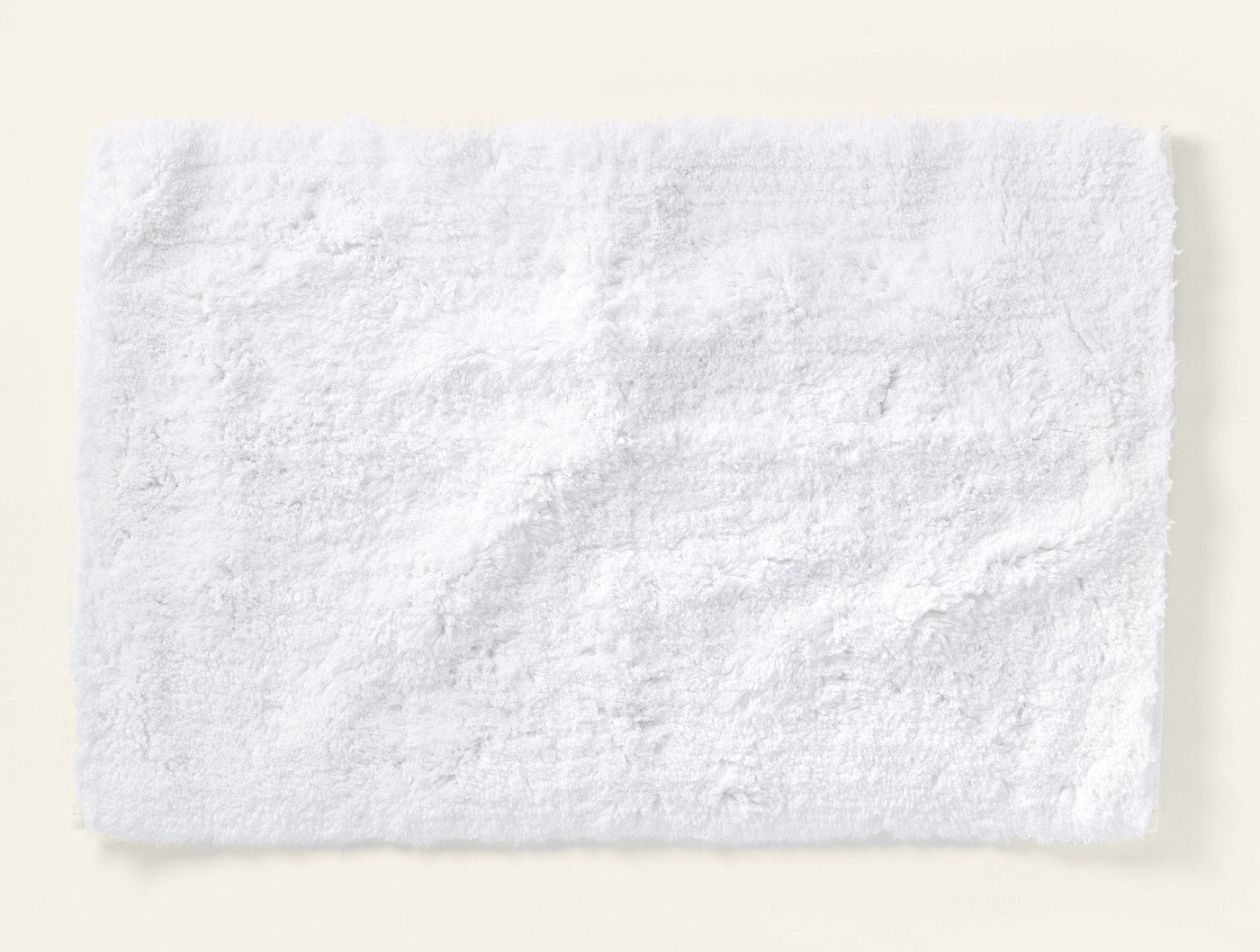 Coyuchi Shag bath rug in white, plush terry pile texture, laid flat.