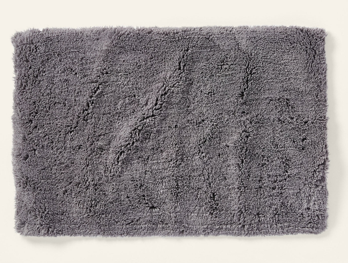 Coyuchi Shag bath rug in slate grey, close-up showing plush tufted texture.