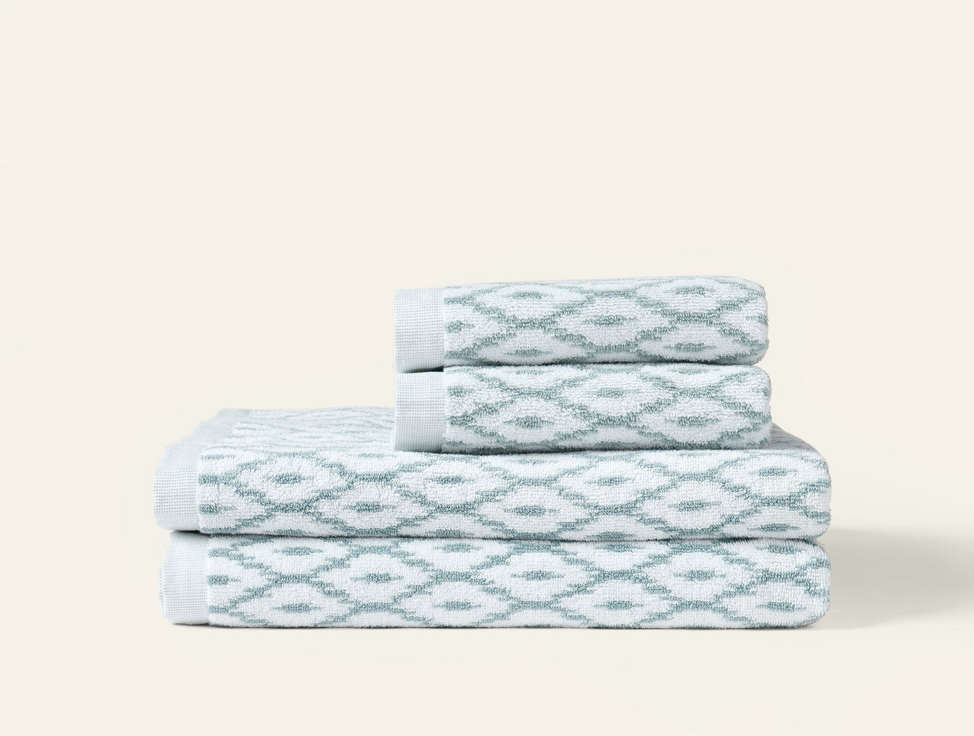Coyuchi Stinson bath set in seafoam ikat pattern, four pieces folded and stacked.