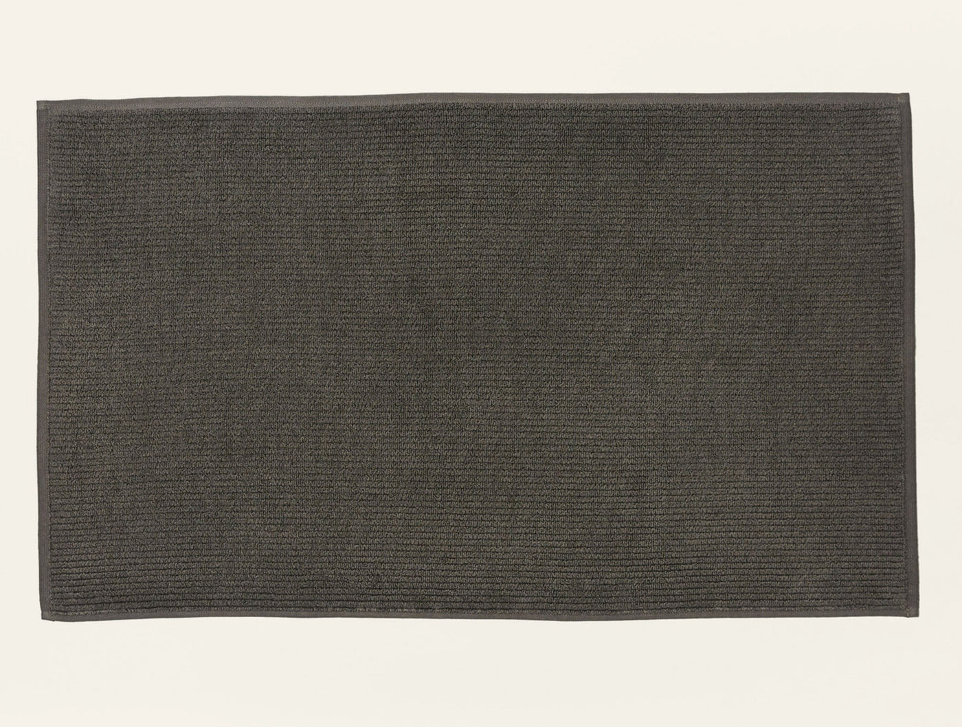 Coyuchi Temescal ribbed bath rug in charcoal, flat lay showing ribbed texture.