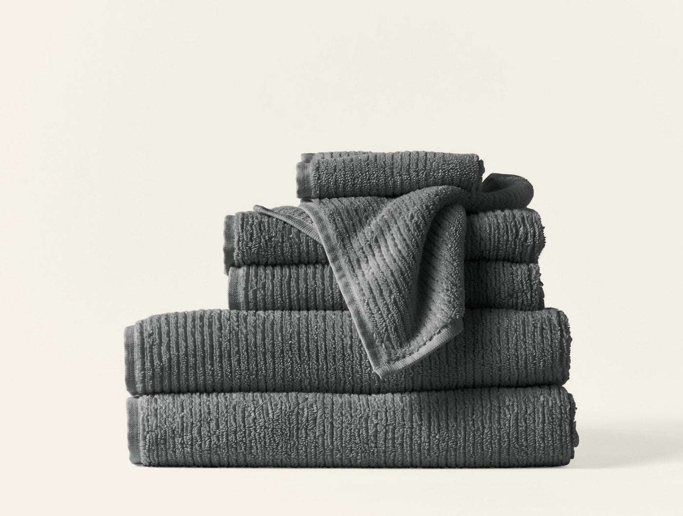 Stacked Coyuchi Temescal Ribbed towel set in graphite, showing ribbed texture detail.